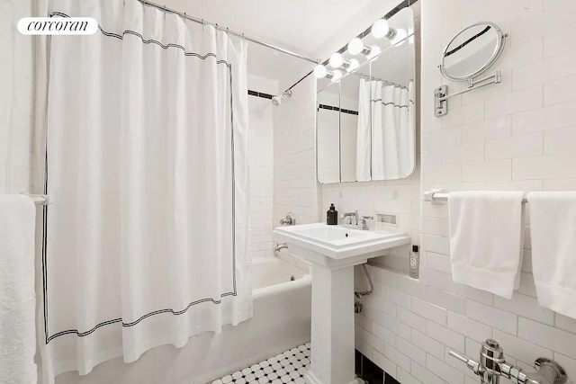 405 W 23rd St Unit 14F, New York City, NY 10011 - full bath featuring tile walls, shower / bath combination with curtain, and decorative backsplash