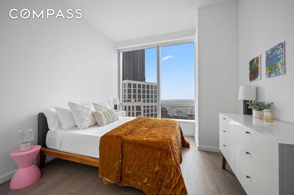 bedroom featuring baseboards and wood finished floors