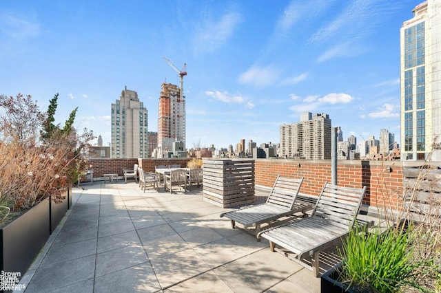 view of patio with a city view and outdoor dining area