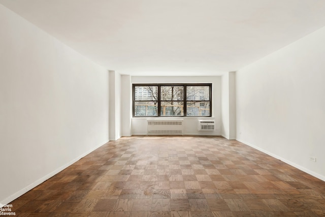 165 W End Ave Unit 2J, New York City, NY 10023 - unfurnished room with radiator, baseboards, and a wall unit AC