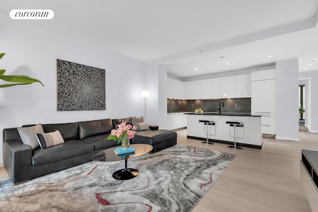4 W 21st St Unit 4B, New York City, NY 10010 - living area with light wood-style floors, recessed lighting, and baseboards
