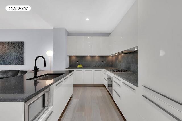 4 W 21st St Unit 4B, New York City, NY 10010 - kitchen featuring a sink, modern cabinets, white cabinets, appliances with stainless steel finishes, and recessed lighting