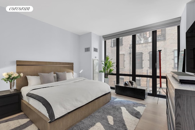 4 W 21st St Unit 4B, New York City, NY 10010 - bedroom with expansive windows, multiple windows, and light wood-type flooring