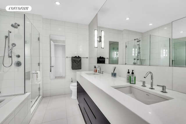 4 W 21st St Unit 4B, New York City, NY 10010 - full bathroom with a stall shower, tile patterned flooring, double vanity, tile walls, and toilet