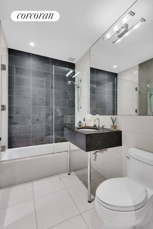 4 W 21st St Unit 4B, New York City, NY 10010 - bathroom with  shower combination, toilet, tile walls, a sink, and tile patterned floors