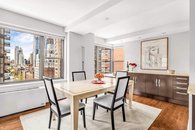 55 E End Ave Unit 12Hj, New York City, NY 10028 - dining room featuring recessed lighting, a view of city, and wood finished floors