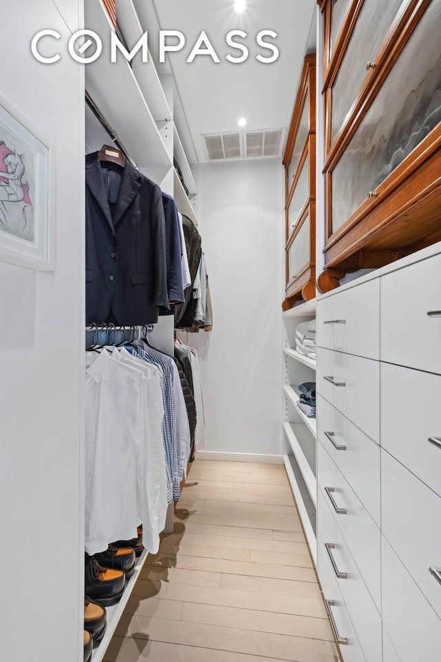 spacious closet with light wood-style floors