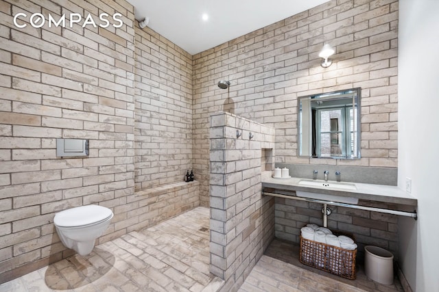 bathroom with a sink, walk in shower, and toilet