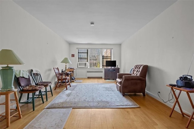 620 W 239th St Unit 6B, New York City, NY 10463 - living area featuring baseboards, radiator heating unit, cooling unit, and wood finished floors