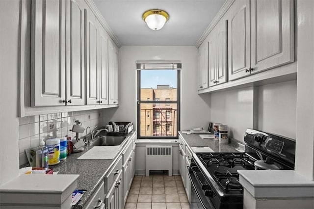 620 W 239th St Unit 6B, New York City, NY 10463 - kitchen with radiator, white cabinets, a sink, tasteful backsplash, and black range with gas cooktop