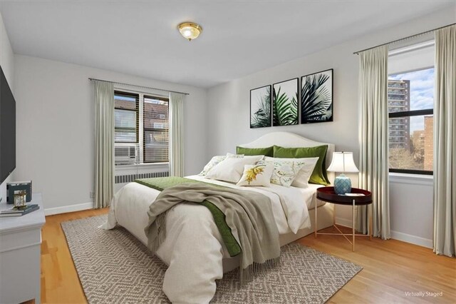 620 W 239th St Unit 6B, New York City, NY 10463 - bedroom featuring baseboards and light wood-style floors