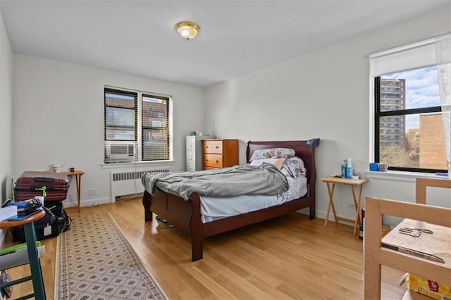 620 W 239th St Unit 6B, New York City, NY 10463 - bedroom featuring radiator heating unit, baseboards, and light wood-style flooring