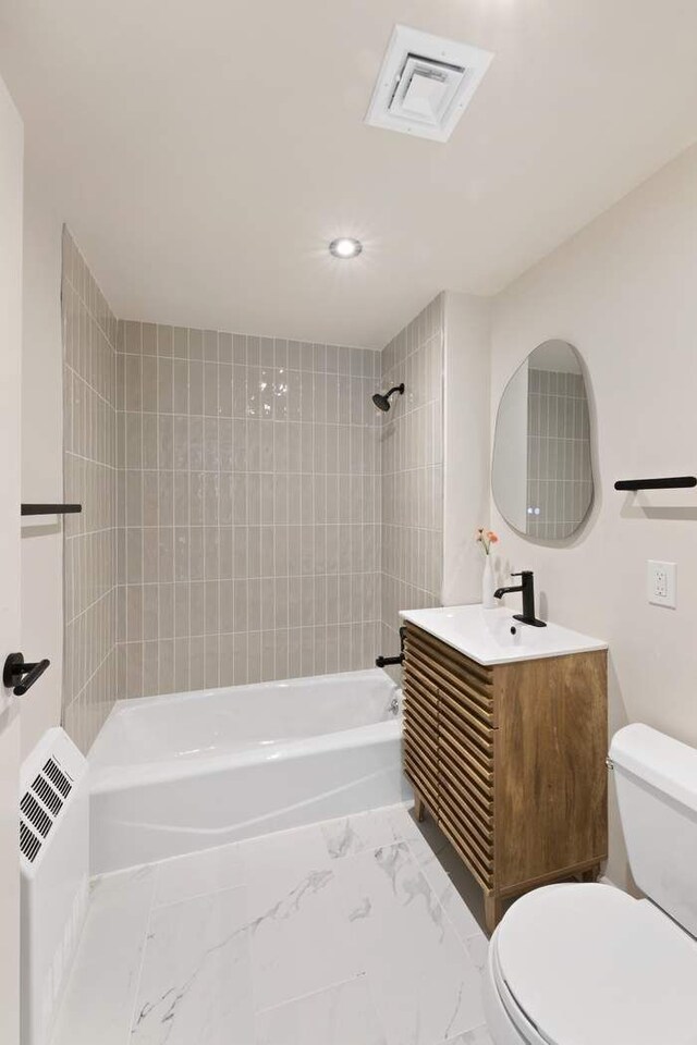 603 W 148th St Unit 3A, New York City, NY 10031 - bathroom featuring toilet, washtub / shower combination, vanity, recessed lighting, and marble finish floors