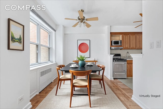11 Riverside Dr Unit 2He, New York City, NY 10023 - dining space with radiator, a ceiling fan, baseboards, and light wood-style flooring