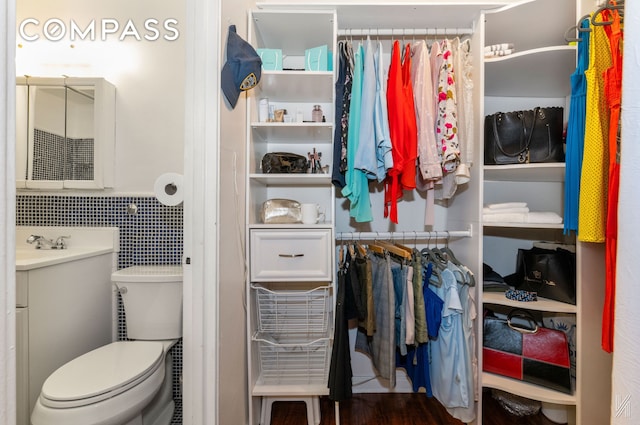 39-30 52nd St Unit 5E, New York City, NY 11377 - bathroom with vanity, toilet, tile walls, and wainscoting