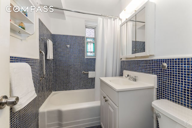 full bath featuring toilet, vanity, tile walls, wainscoting, and shower / tub combo