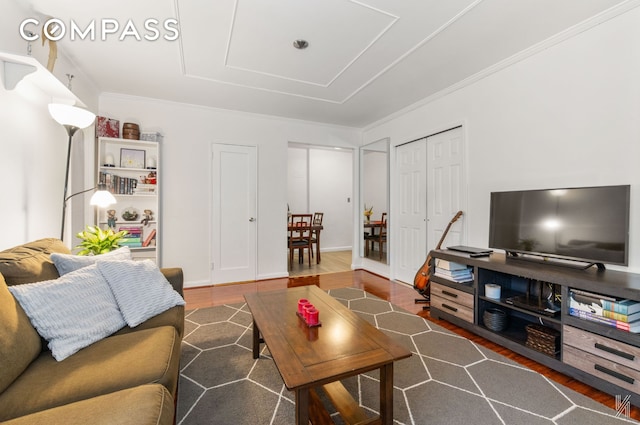 living area featuring ornamental molding and wood finished floors