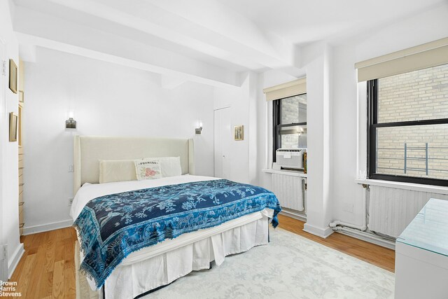 2166 Broadway Unit 16F, New York City, NY 10024 - bedroom with wood finished floors, cooling unit, and radiator heating unit