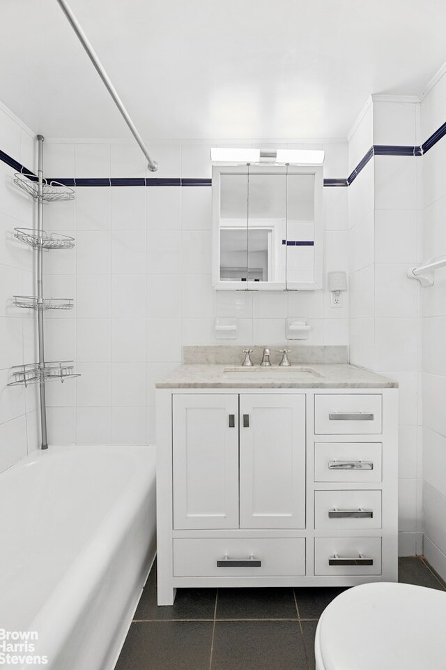 2166 Broadway Unit 16F, New York City, NY 10024 - full bath with tile patterned flooring, vanity, shower / bathtub combination, and tile walls