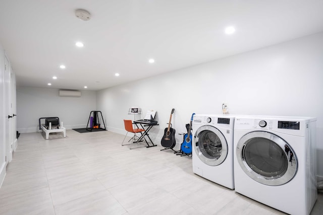 washroom with baseboards, recessed lighting, washer and dryer, and a wall unit AC