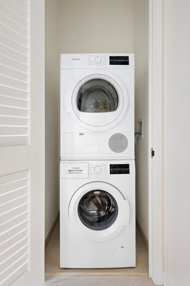 959 1st Ave Unit 25E, New York City, NY 10022 - washroom with stacked washer / dryer and baseboards
