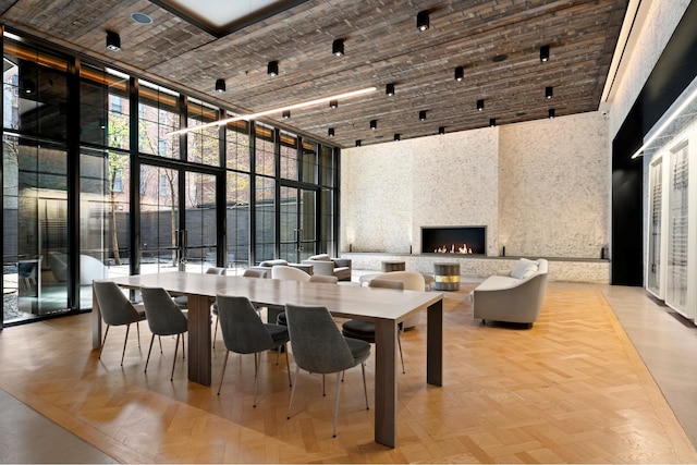 959 1st Ave Unit 25E, New York City, NY 10022 - dining space with a towering ceiling, expansive windows, and a fireplace