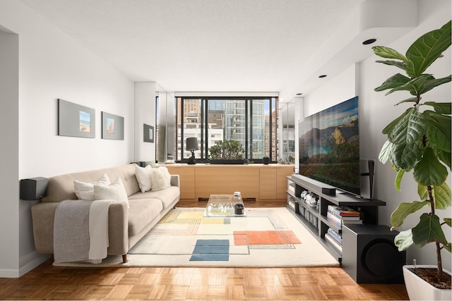 living room featuring baseboards and floor to ceiling windows