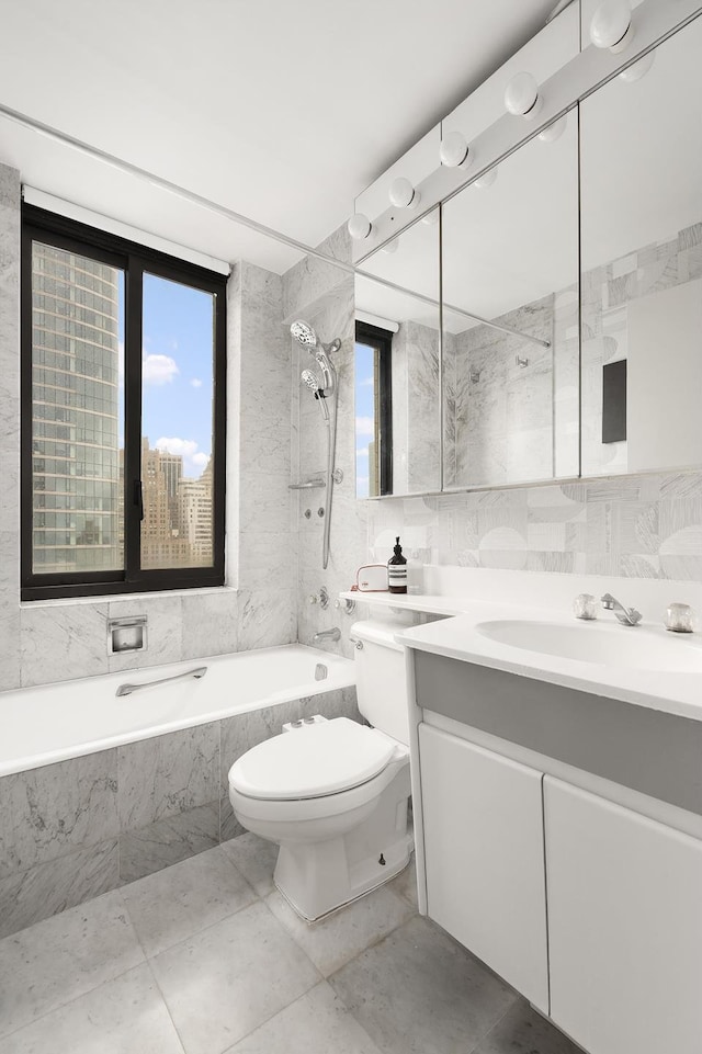 bathroom featuring toilet, tile walls, vanity, and a wealth of natural light