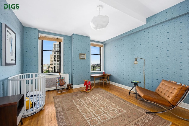 bedroom with wood finished floors and baseboards