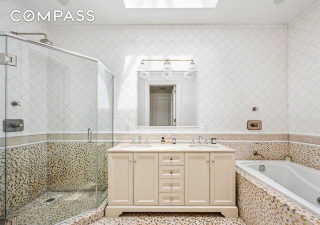 full bathroom with a bath, a stall shower, double vanity, and a skylight