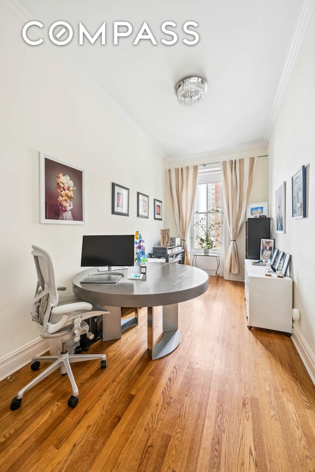 home office with ornamental molding, light wood-type flooring, and baseboards