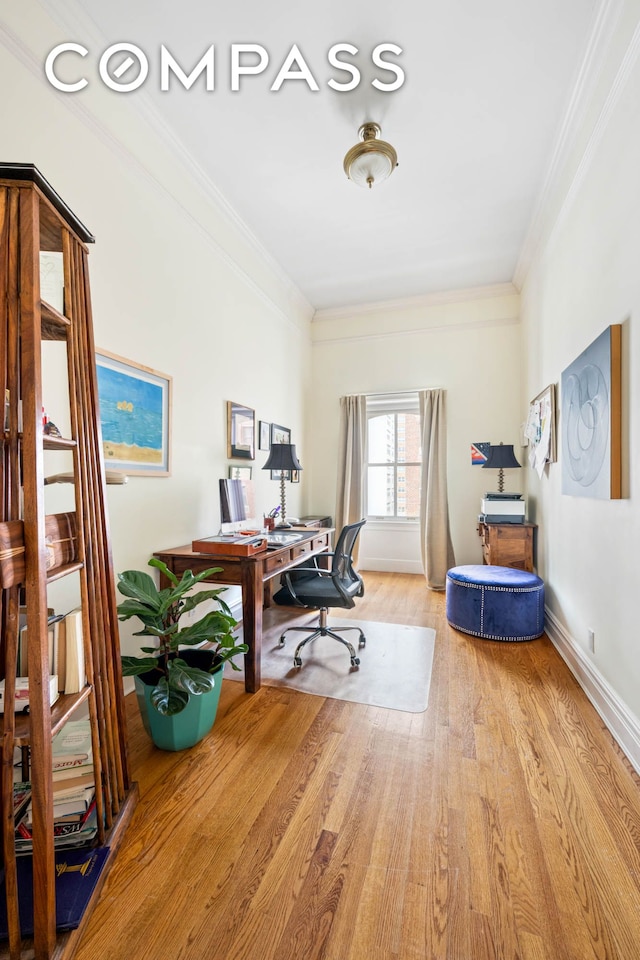office space featuring ornamental molding, wood finished floors, and baseboards