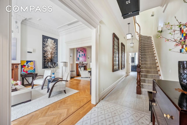 hall with stairs, ornamental molding, and baseboards