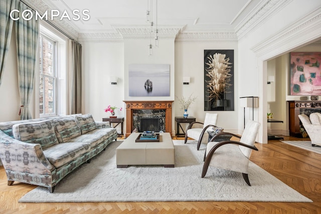living area with a high end fireplace and ornamental molding