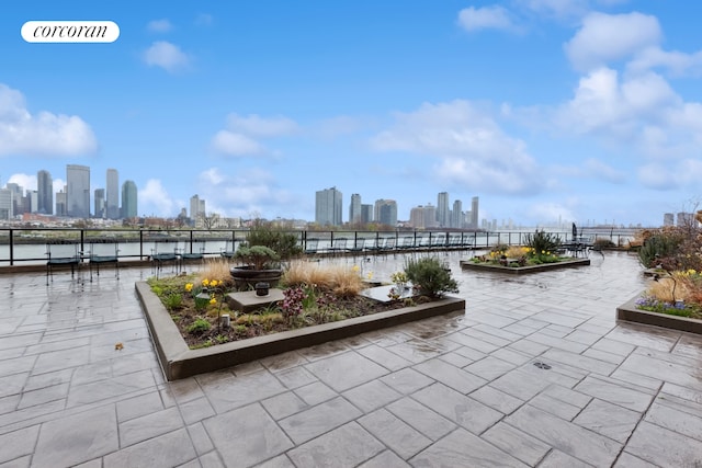 25 Sutton Pl S Unit 16O, New York City, NY 10022 - view of patio / terrace with a view of skyline and a water view