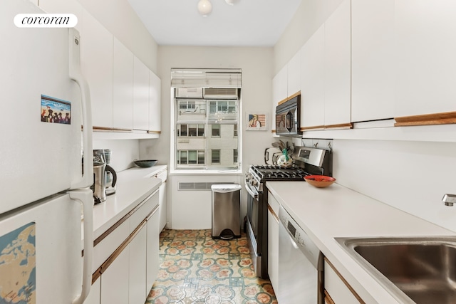 25 Sutton Pl S Unit 16O, New York City, NY 10022 - kitchen featuring freestanding refrigerator, dishwashing machine, stainless steel gas stove, black microwave, and a sink