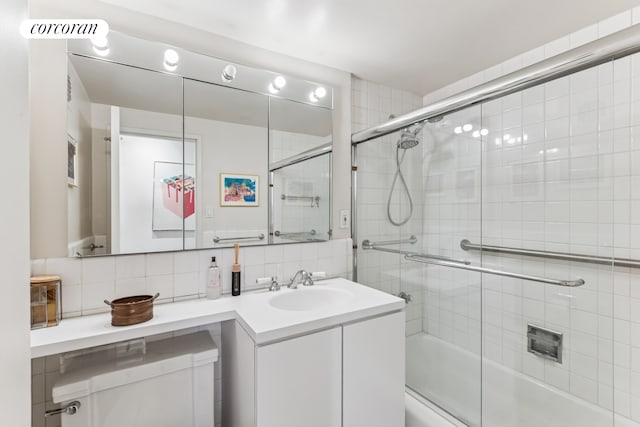 25 Sutton Pl S Unit 16O, New York City, NY 10022 - bathroom featuring tasteful backsplash, bath / shower combo with glass door, and vanity
