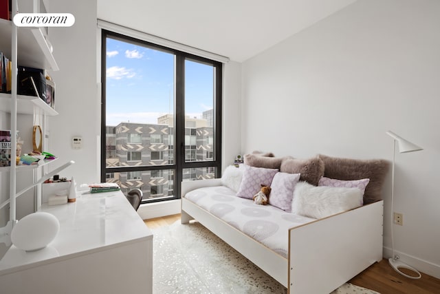 23 W 116th St Unit 12D, New York City, NY 10026 - bedroom featuring light wood finished floors and expansive windows