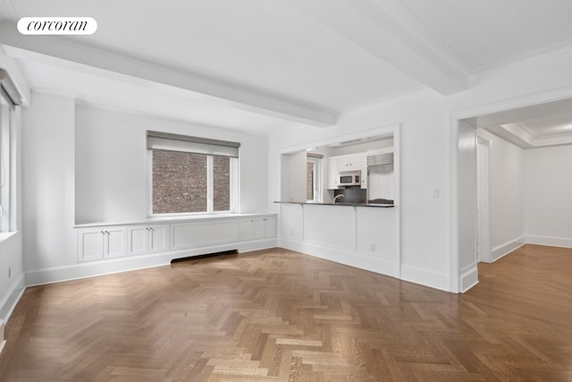 530 Park Ave Unit 5H, New York City, NY 10065 - unfurnished living room featuring crown molding, beam ceiling, and baseboards