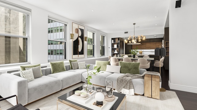 living room featuring visible vents, a wealth of natural light, wood finished floors, and a chandelier