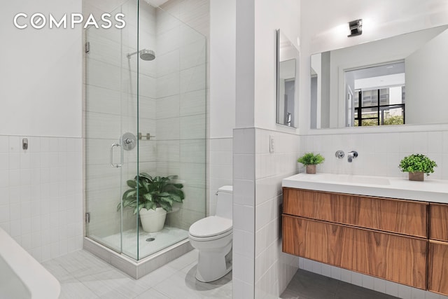 360 Furman St Unit 320/321, New York City, NY 11201 - full bathroom featuring tile walls, a shower stall, tile patterned flooring, a wainscoted wall, and toilet
