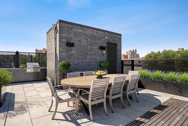 438 E 12th St Phd, Phd, New York City, NY 10009 - view of patio featuring fence, grilling area, exterior kitchen, and outdoor dining space