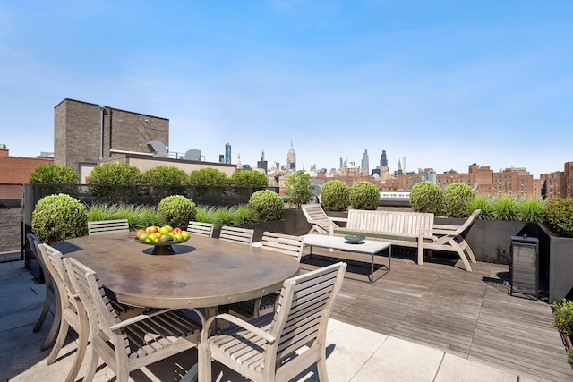 438 E 12th St Phd, Phd, New York City, NY 10009 - view of patio / terrace with a deck, fence, a city view, and outdoor dining space