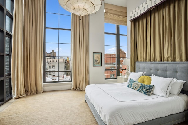 438 E 12th St Phd, Phd, New York City, NY 10009 - bedroom with a city view, a towering ceiling, and multiple windows