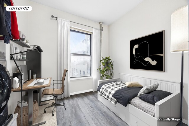551 W 160th St Unit 5B, New York City, NY 10032 - bedroom with wood finished floors, baseboards, and a desk