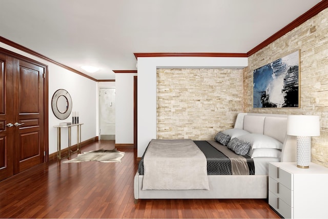 bedroom featuring crown molding, wood-type flooring, and baseboards