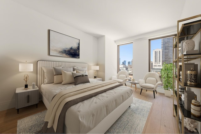 bedroom featuring a city view and light wood-style floors