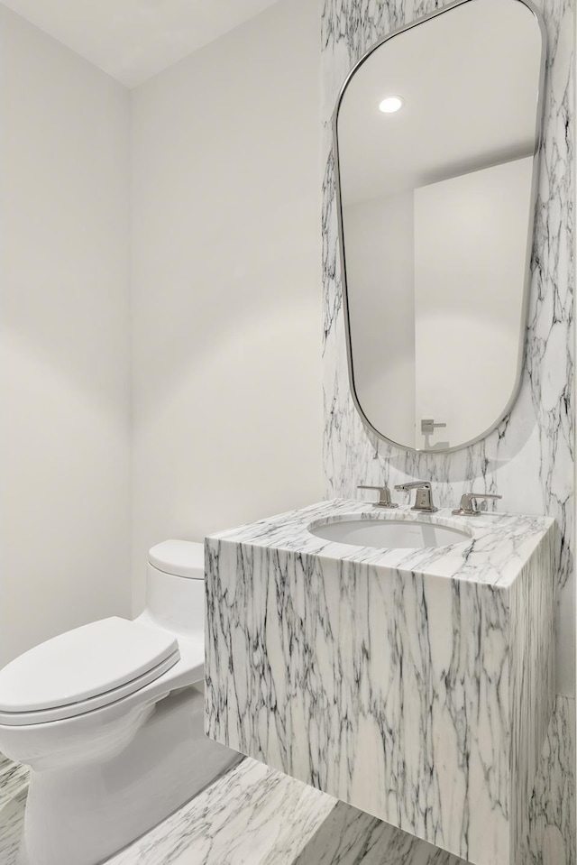 bathroom featuring toilet and vanity