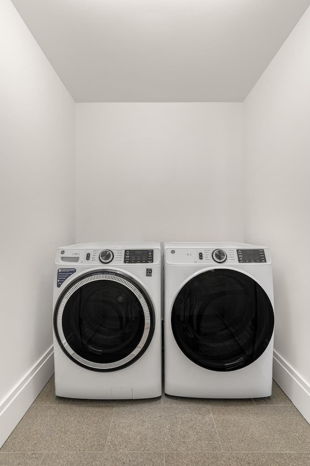 laundry area with baseboards, washing machine and clothes dryer, and laundry area