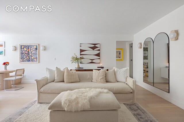living area featuring wood finished floors and baseboards